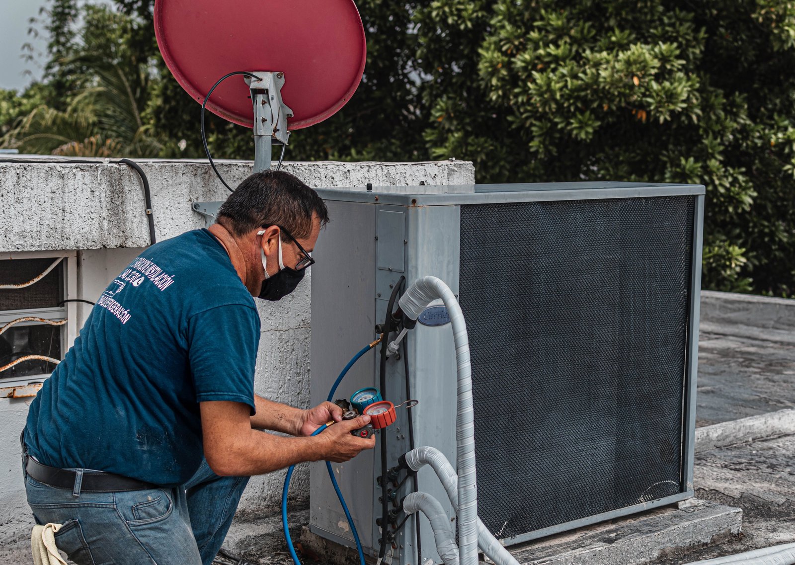 HVAC technician checking an outdoor air conditioning unit for a service page