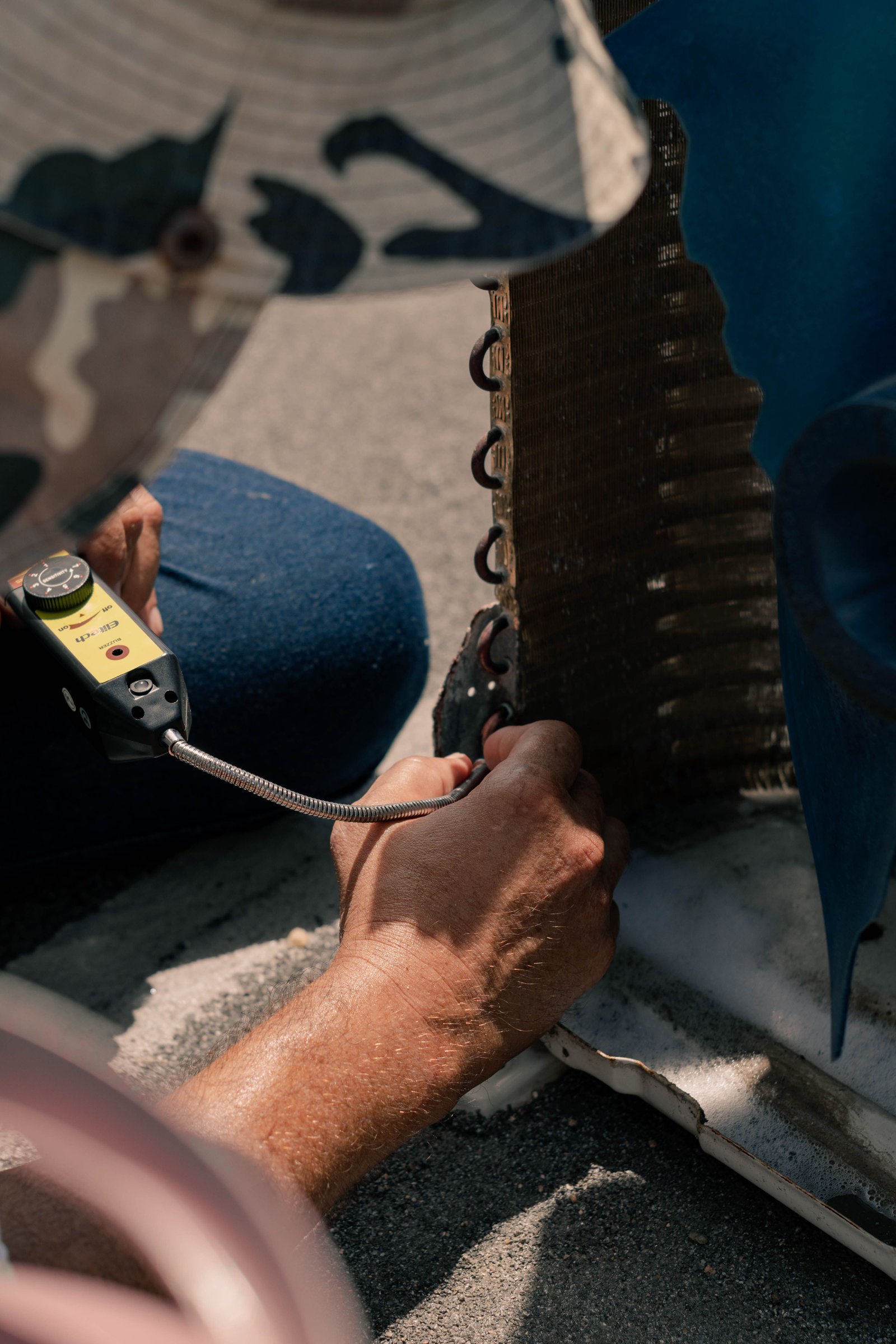 HVAC technician repairing an air conditioner for a cooling service page